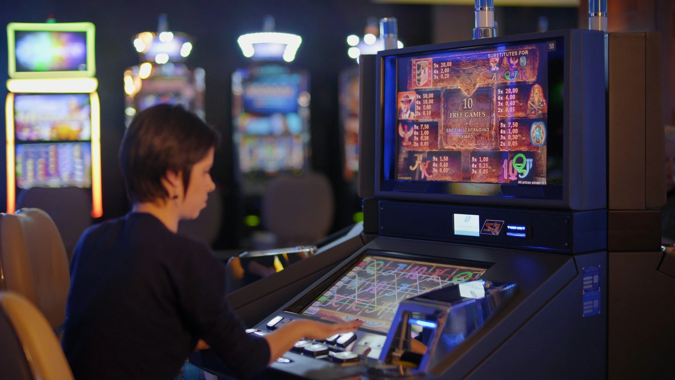 a boy is sitting at a casino slot machine