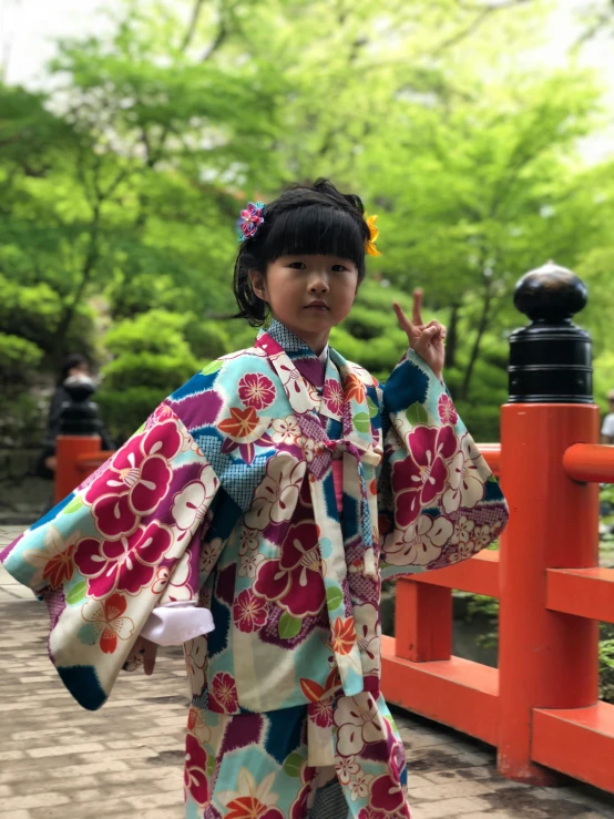 a young child poses in her colorful kimono