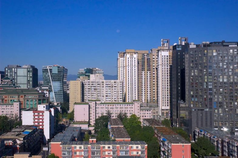 a group of tall buildings standing in front of the city
