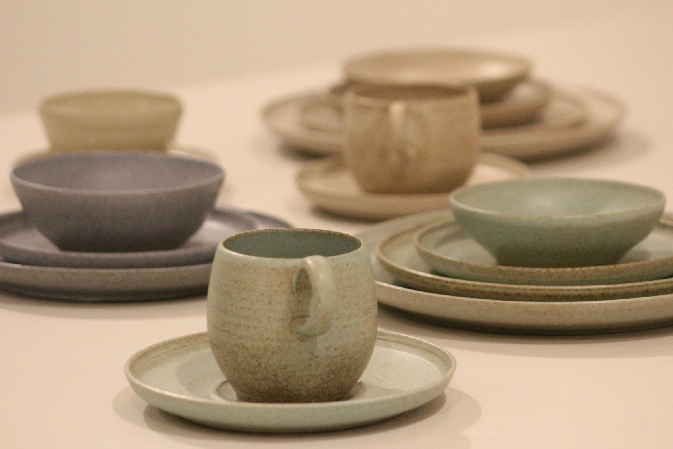 a set of ceramic dishes on a table