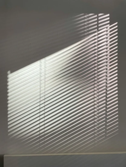 light coming through the window with curtains on it