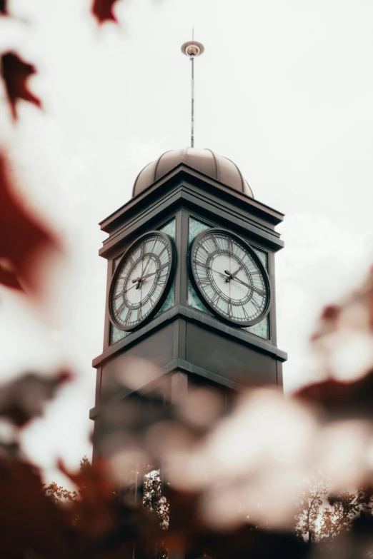 a tall clock tower with two faces on each side of it