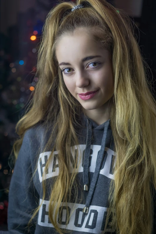 a woman with blond hair in a gray sweatshirt