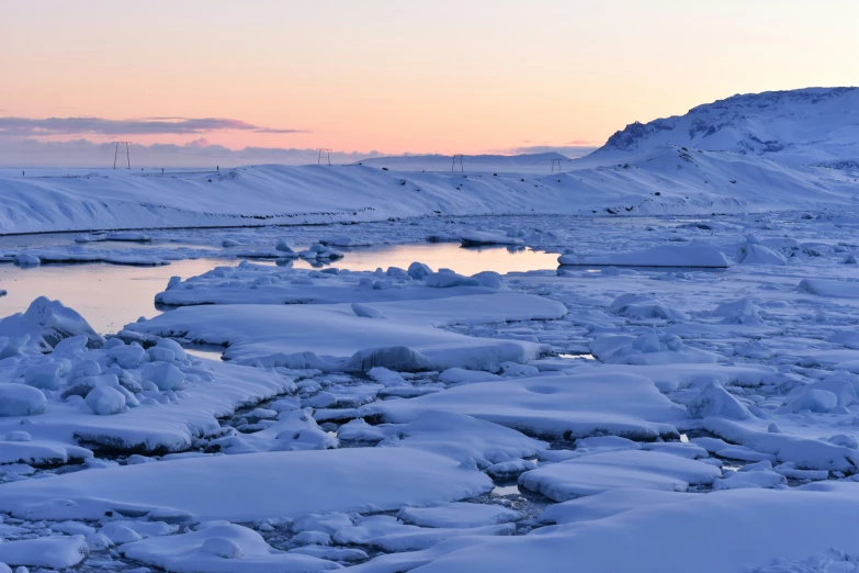 the ocean is frozen and the sun is going down