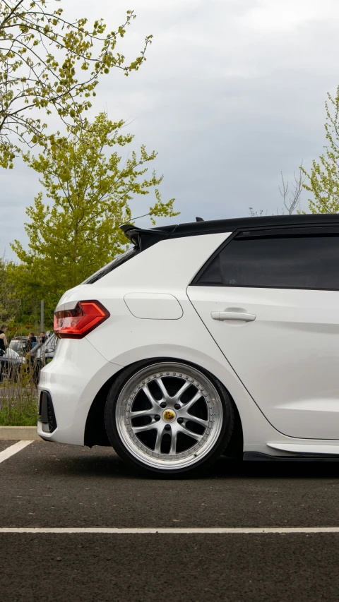 white car parked on street with sky background