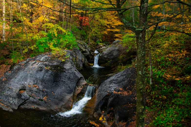 a small waterfall running down into some rocks