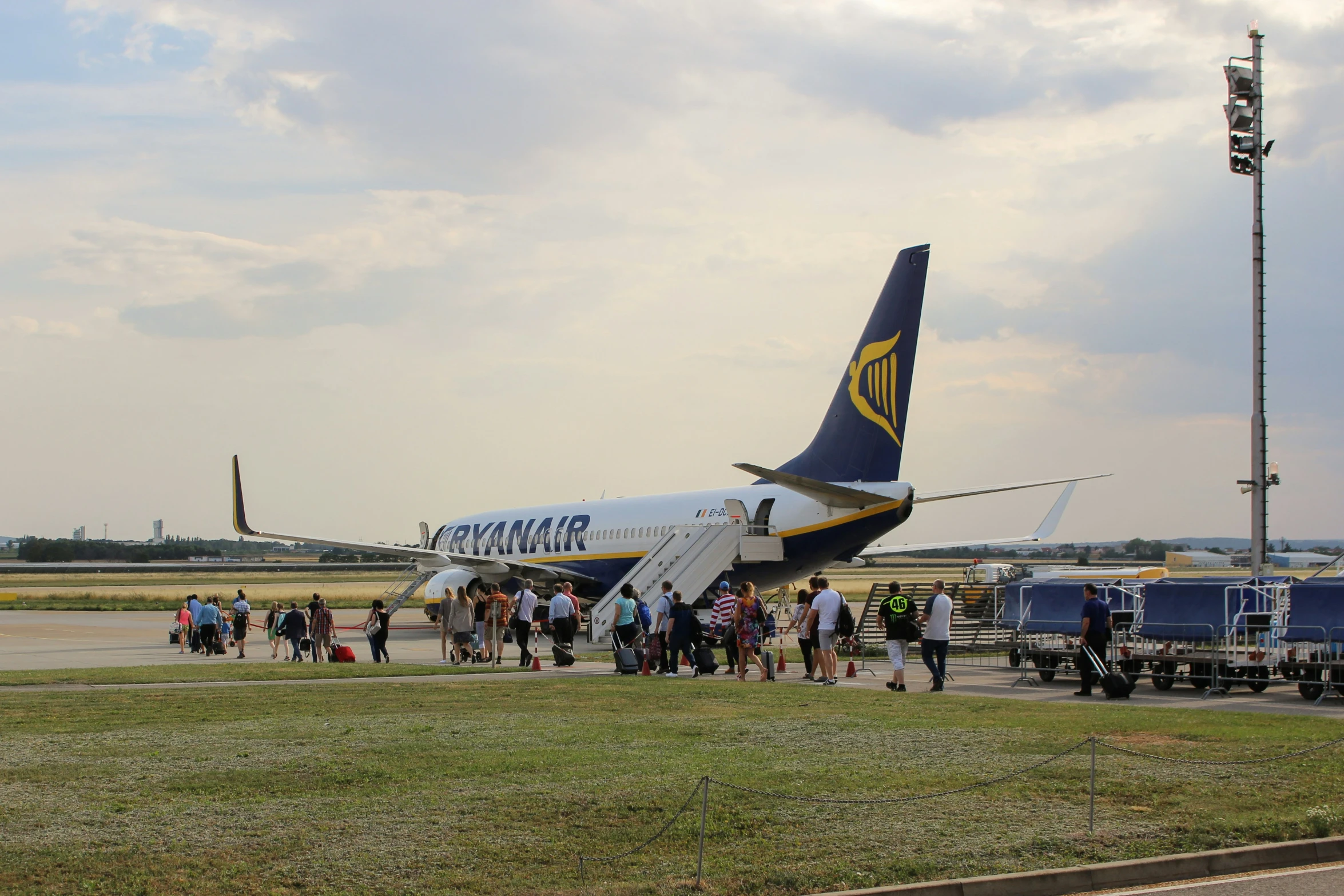 people gather to see a large plane that is parked on the runway