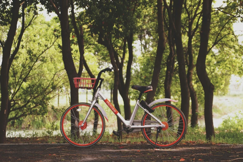 a bicycle parked next to a picnic table outside