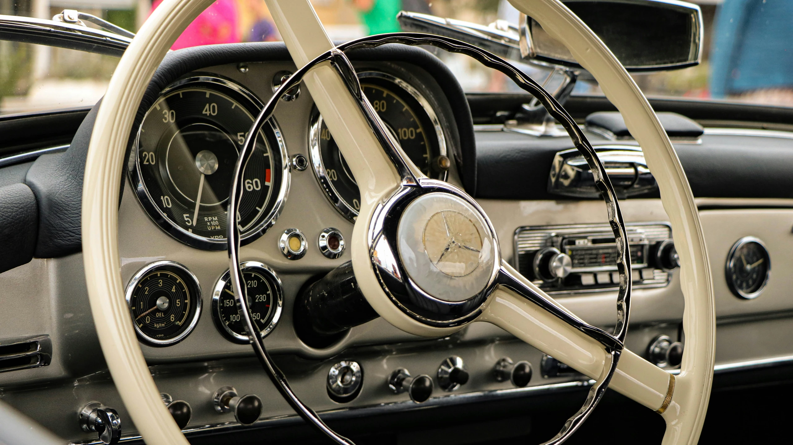the dashboard of a vintage car with dash gauges and steering wheel