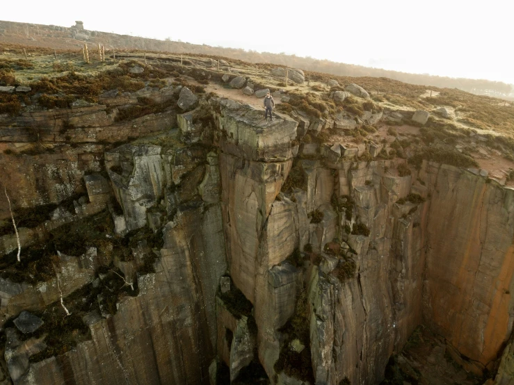 a cliff in the middle of a field