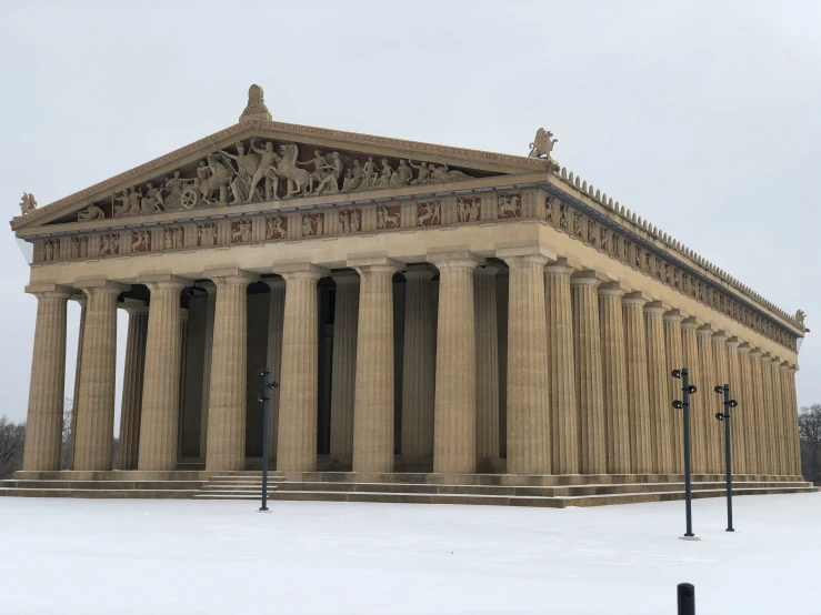 a large stone building sitting on top of a snow covered ground