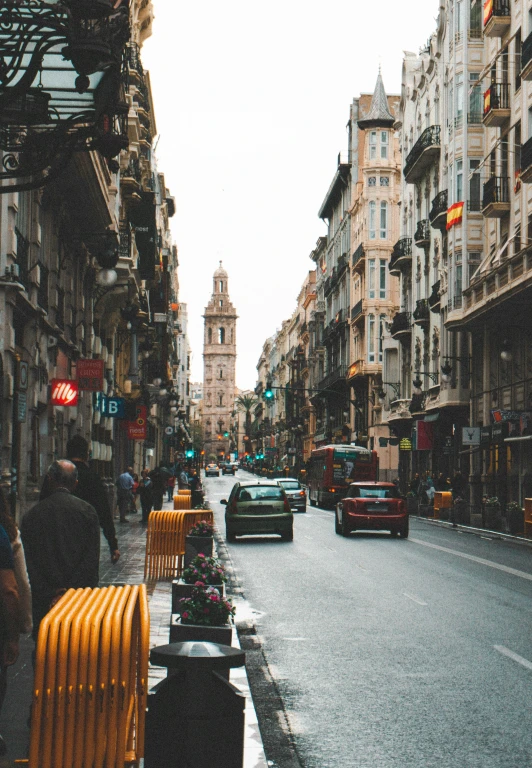 a city street filled with traffic and tall buildings