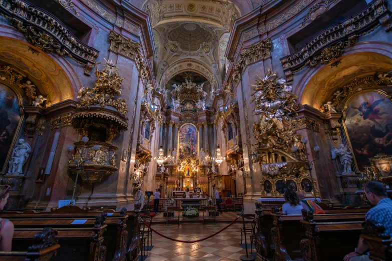 a church with tall ceilings filled with paintings