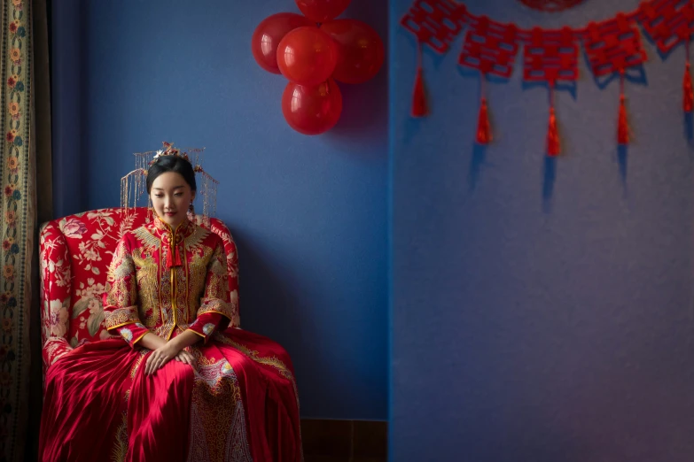 woman sitting in chair dressed in red