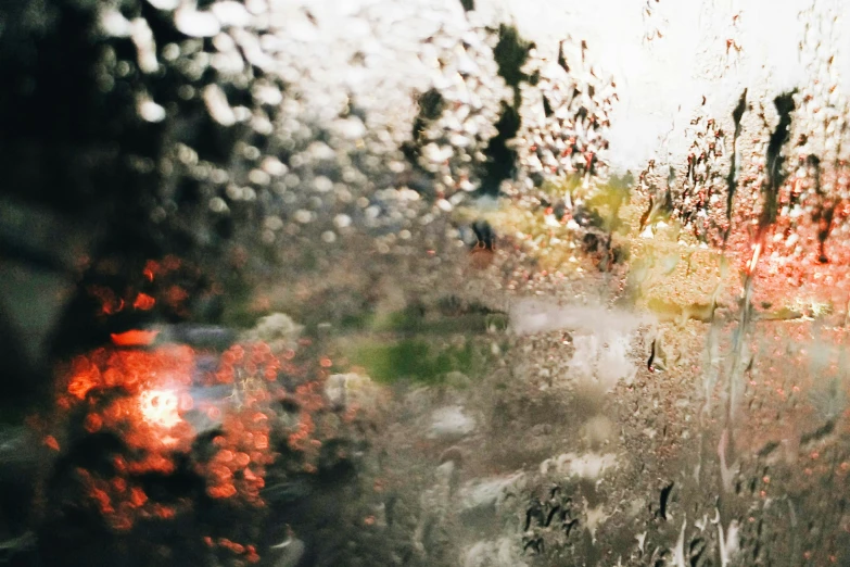 a close up view of some street lights through rain