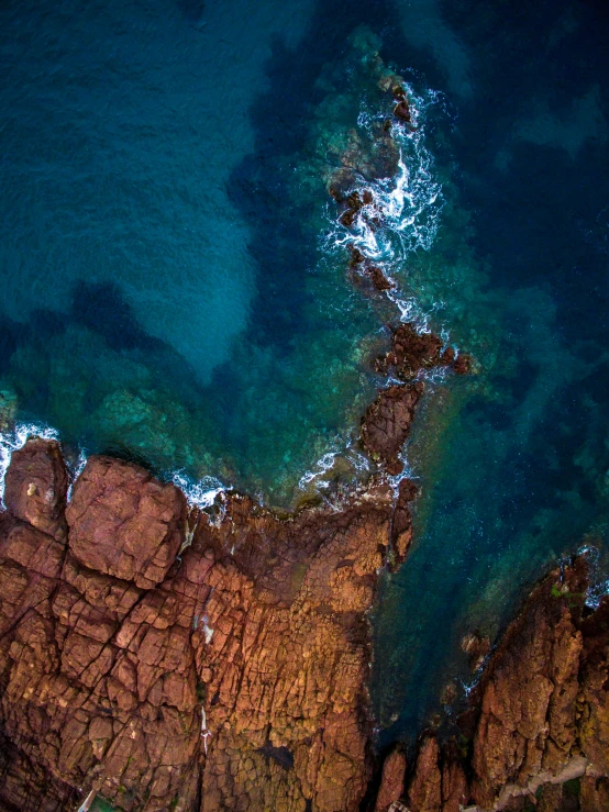 the water near a rocky shore is clear