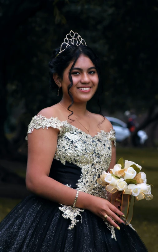 a woman in a black and white dress and a crown