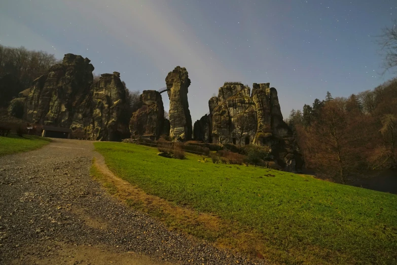 a small dirt road running next to some rocks