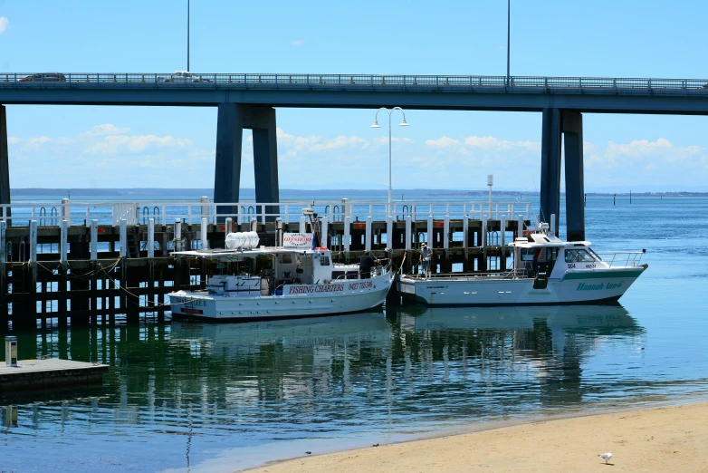 a view of two boats tied up in the ocean