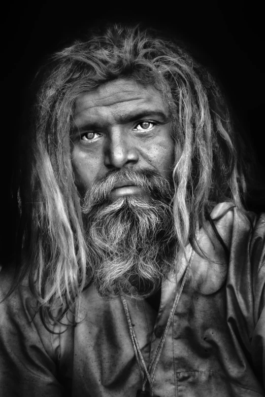 the man with long hair and beard in black and white
