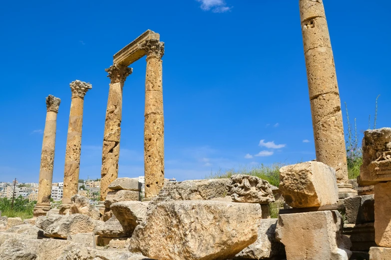 a number of pillars near each other near rocks