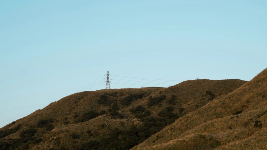 an airplane that is flying over a hill