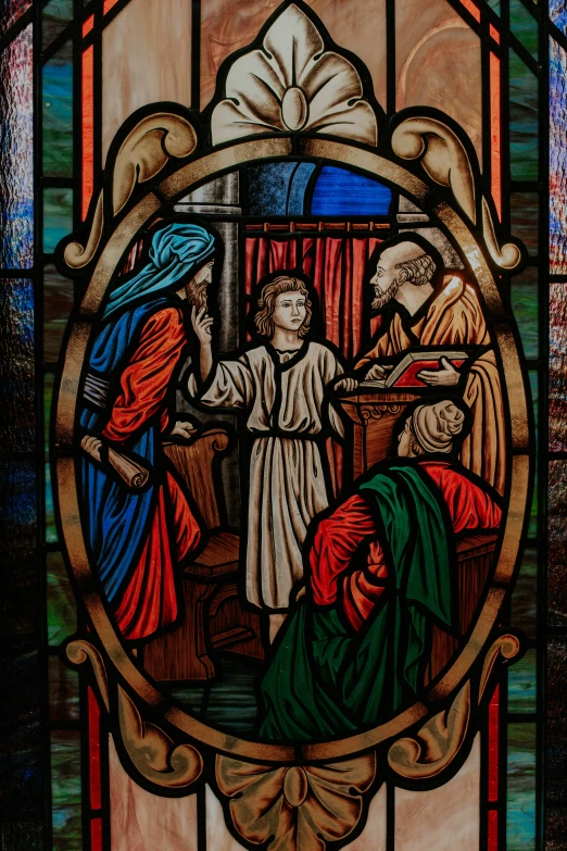a stained glass window with three women sitting next to each other