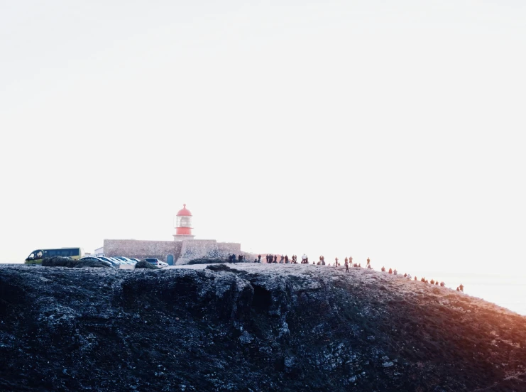 a large lighthouse on top of a rock near the ocean