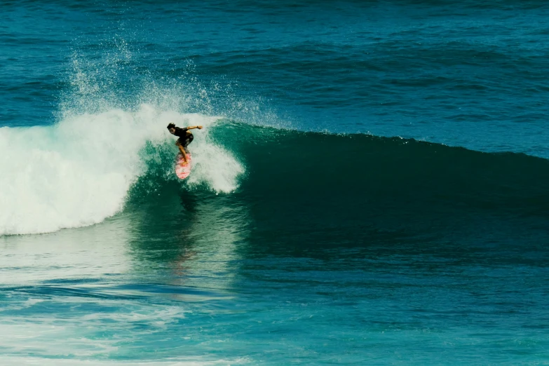 a surfer is on their surfboard riding the waves