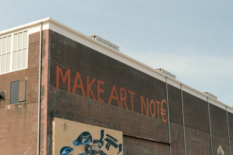 an old building with graffiti on it and a sign that says make art not war