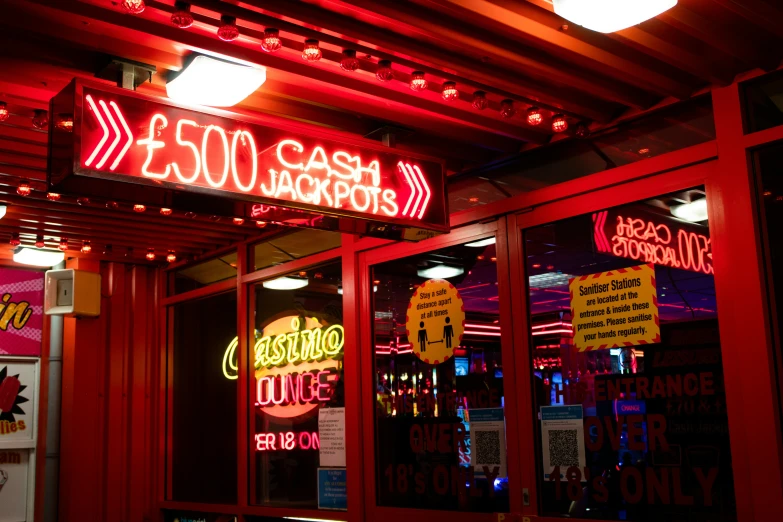 a close up of the lit neon sign above an entrance to a restaurant