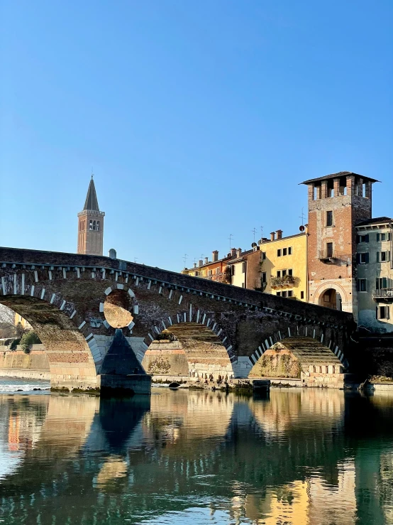 a large brick building next to a bridge