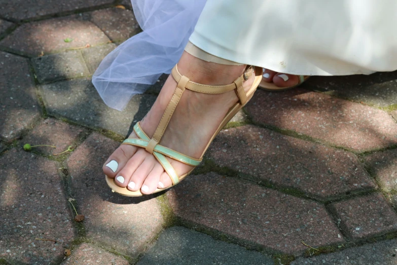 a close up s of a brides shoes on her feet