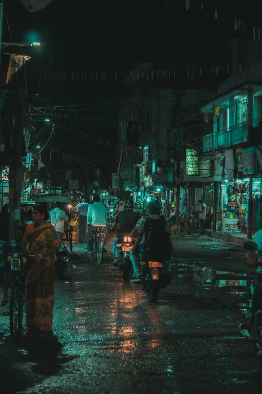 a group of people sitting down in the rain on motorcycles