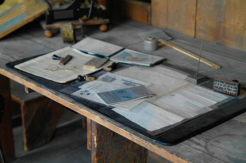 some newspaper lies on a table with a toy bike