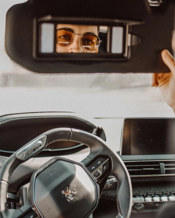 a car with a woman behind a wheel while driving