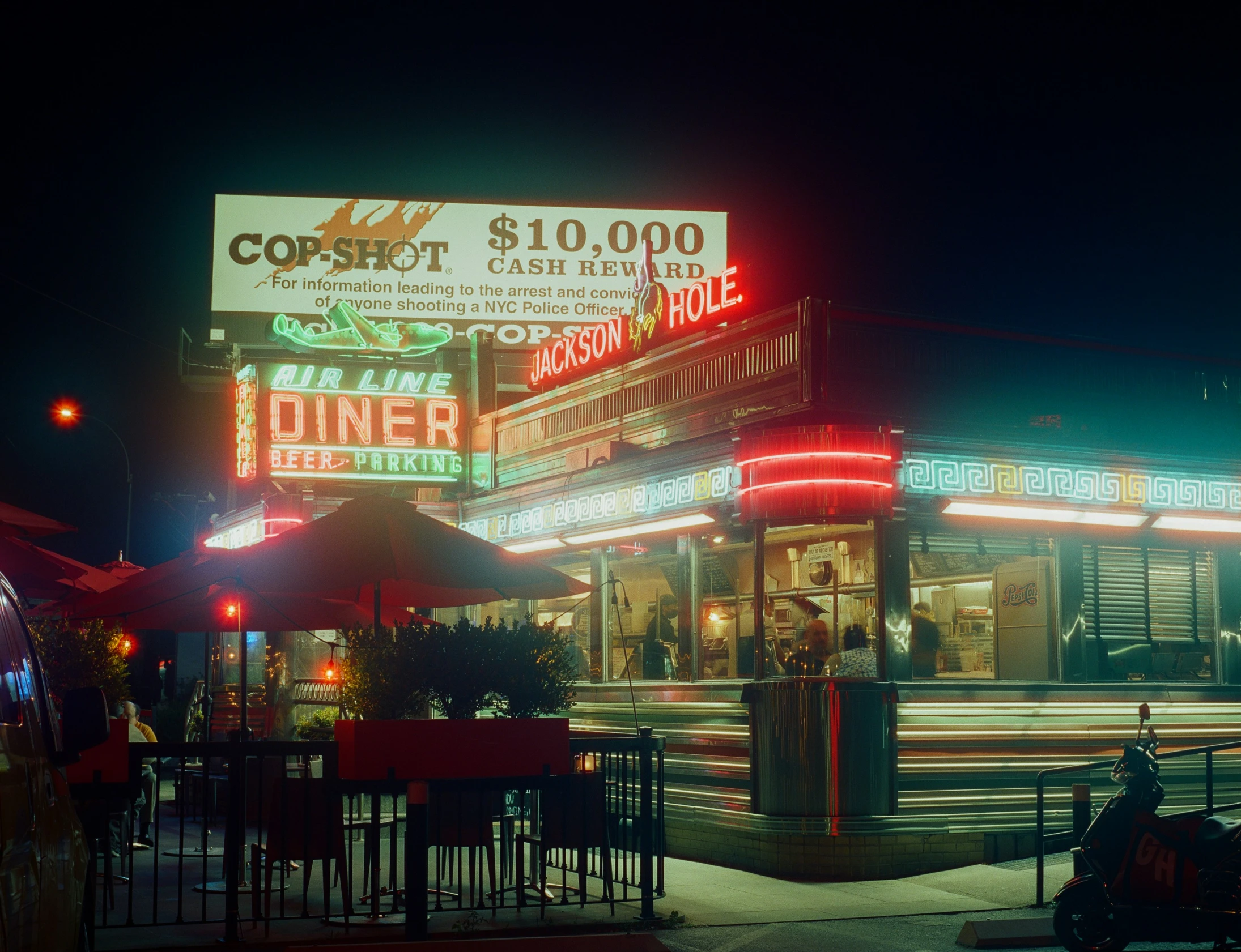 a night scene showing a couple of buildings and food