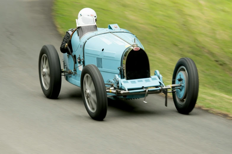 an older model blue buggy is shown in motion