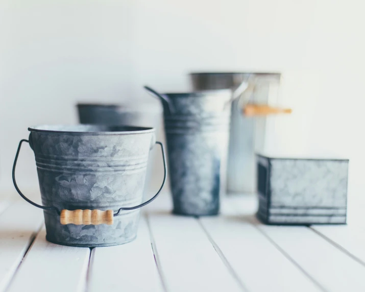 a metal pail filled with different colored buckets