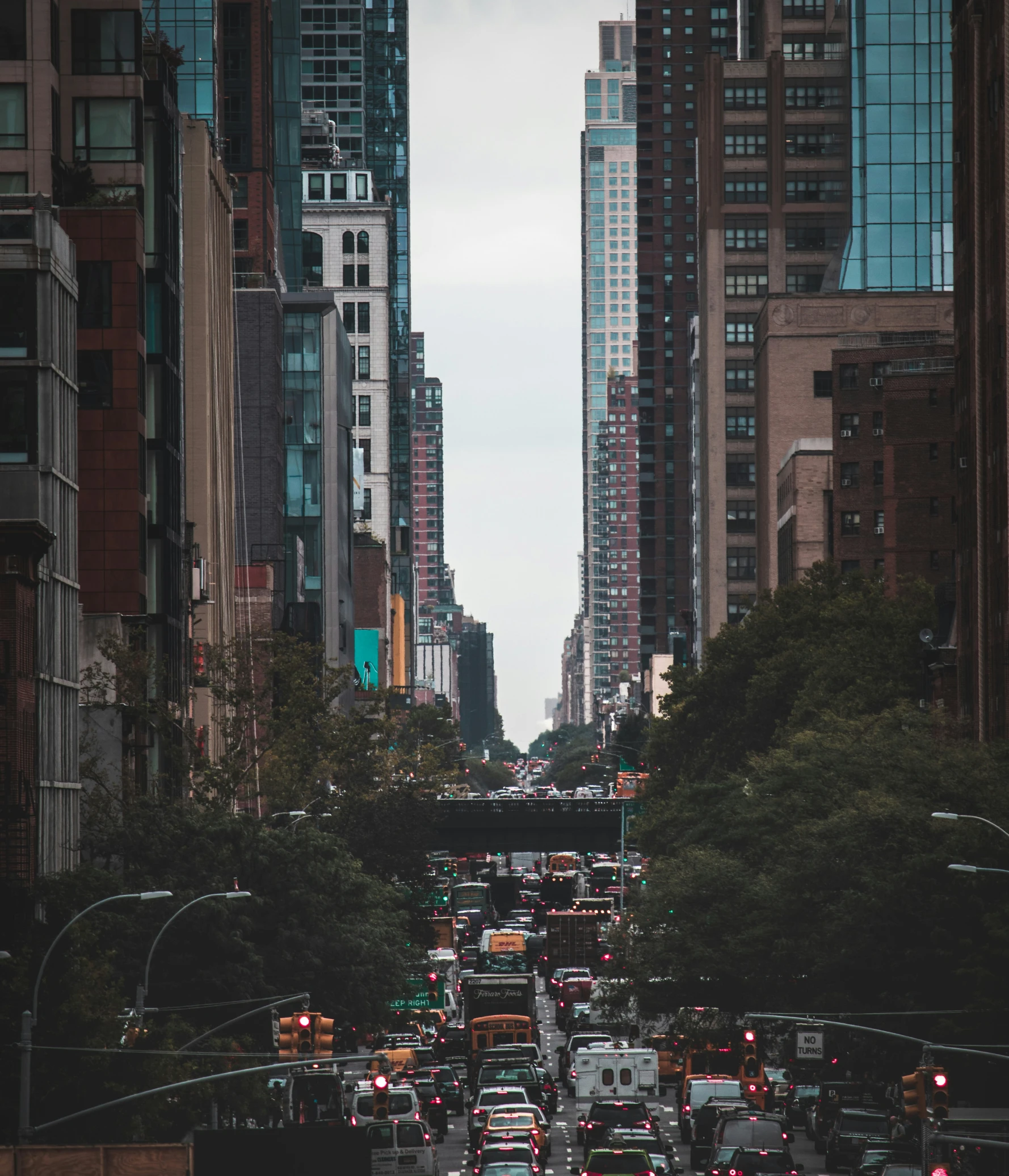 many cars are driving down the city street