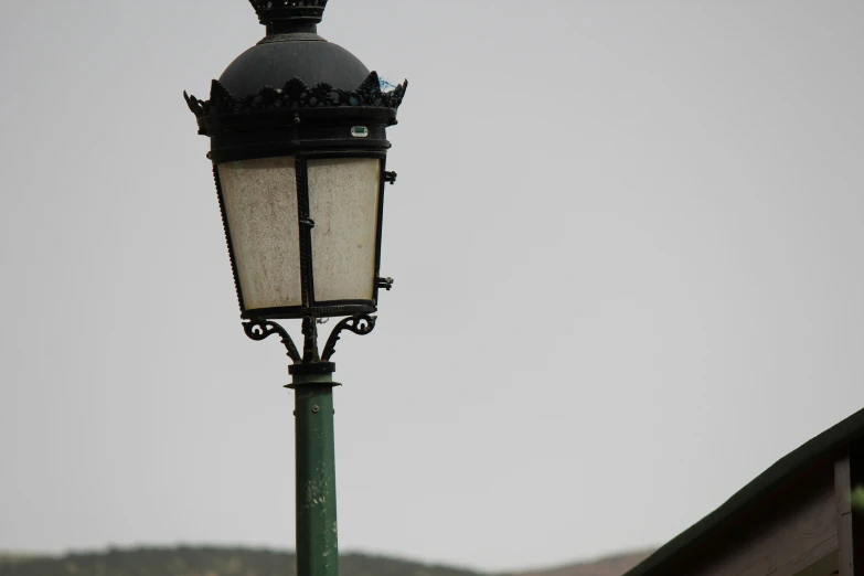 an old fashioned street light on a pole