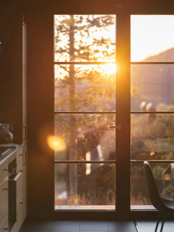 the sun is rising through windows inside a house