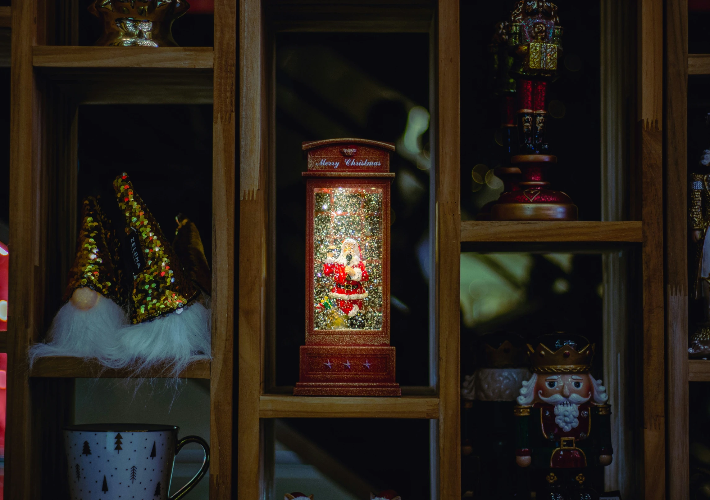 a shelf of a wooden shelf holding various christmas items