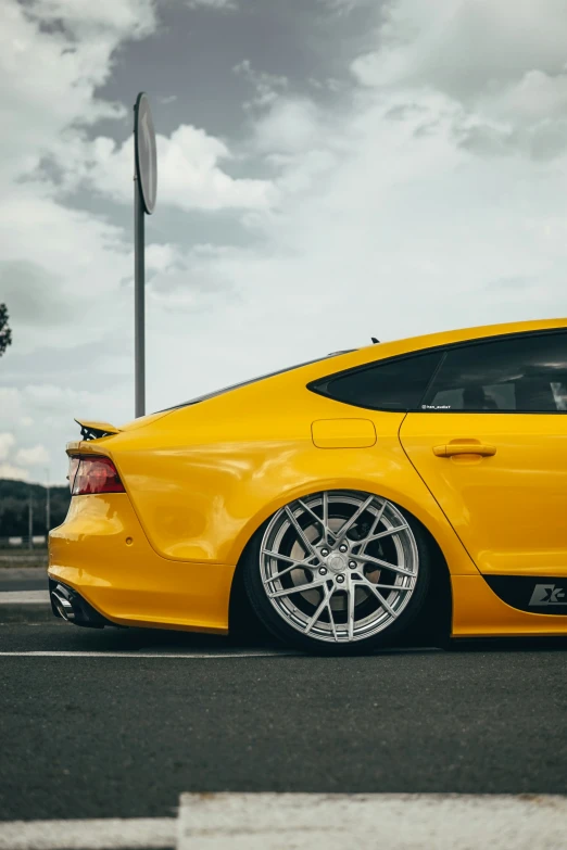 a yellow car parked at a parking lot