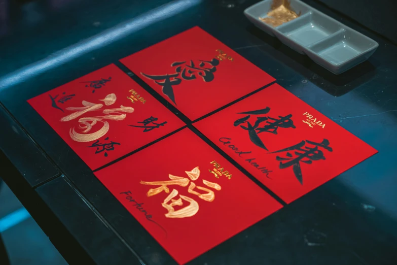 three red packets with chinese writing written on them