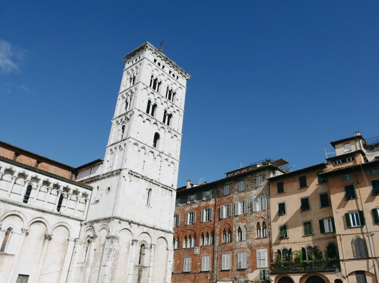 some tall buildings and a white and grey clock tower