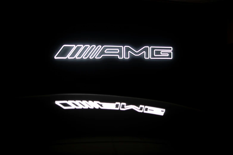 illuminated black and white mercedes emblem in the dark