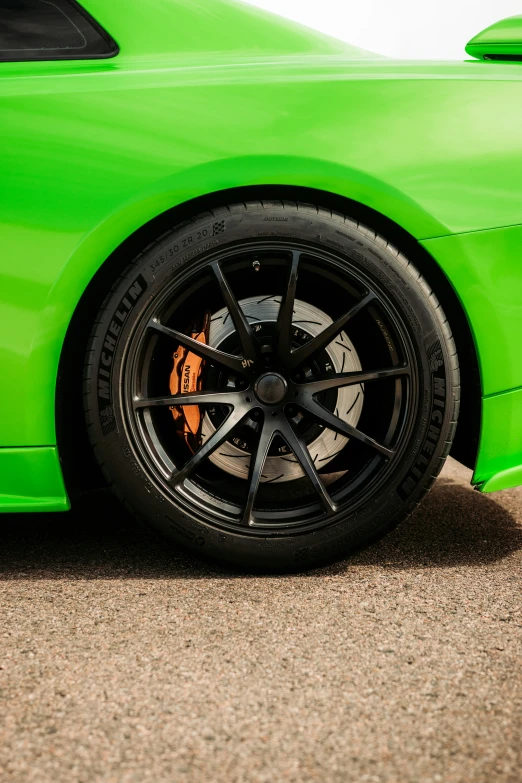 the green sports car has some black rims