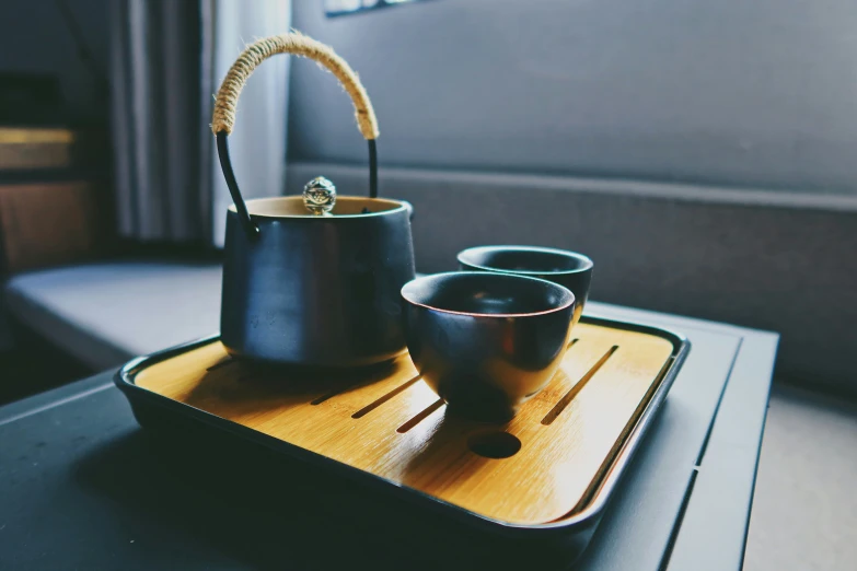 a tray holding two coffee cups sitting on top of a table