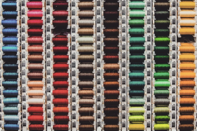 a large variety of spools of thread on a table